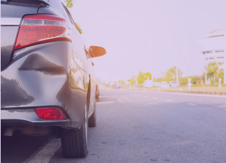 dent on the rear right of a grey car